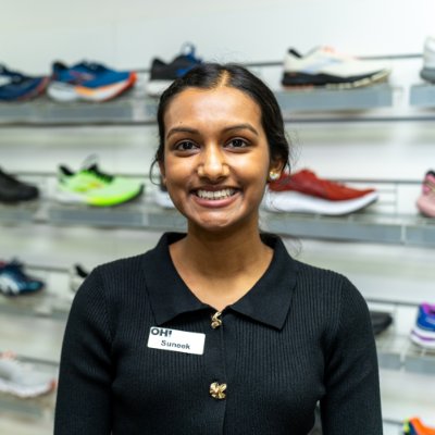 Podiatrist in front of the footwear wall at Toowoomba Heel Pain Clinic