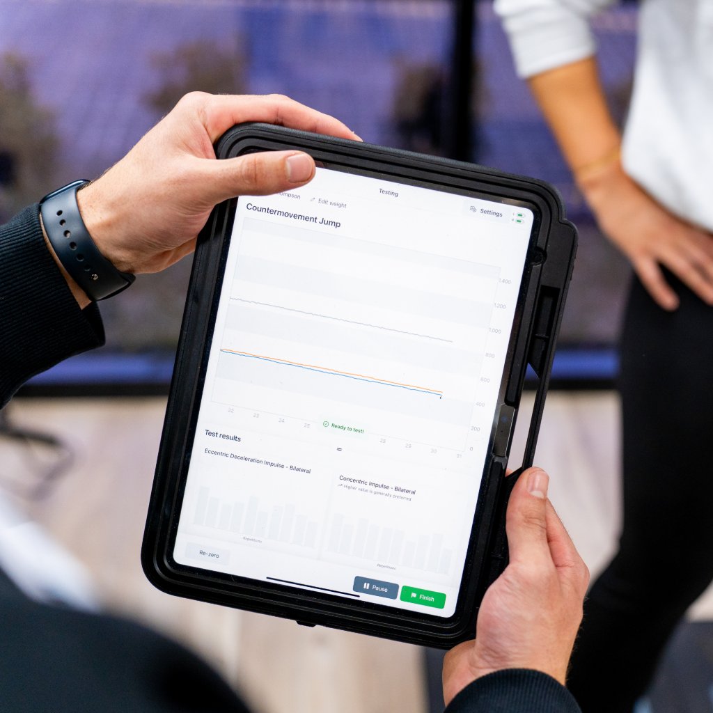 Podiatrist reviewing heel pain assessment results on a tablet in Toowoomba